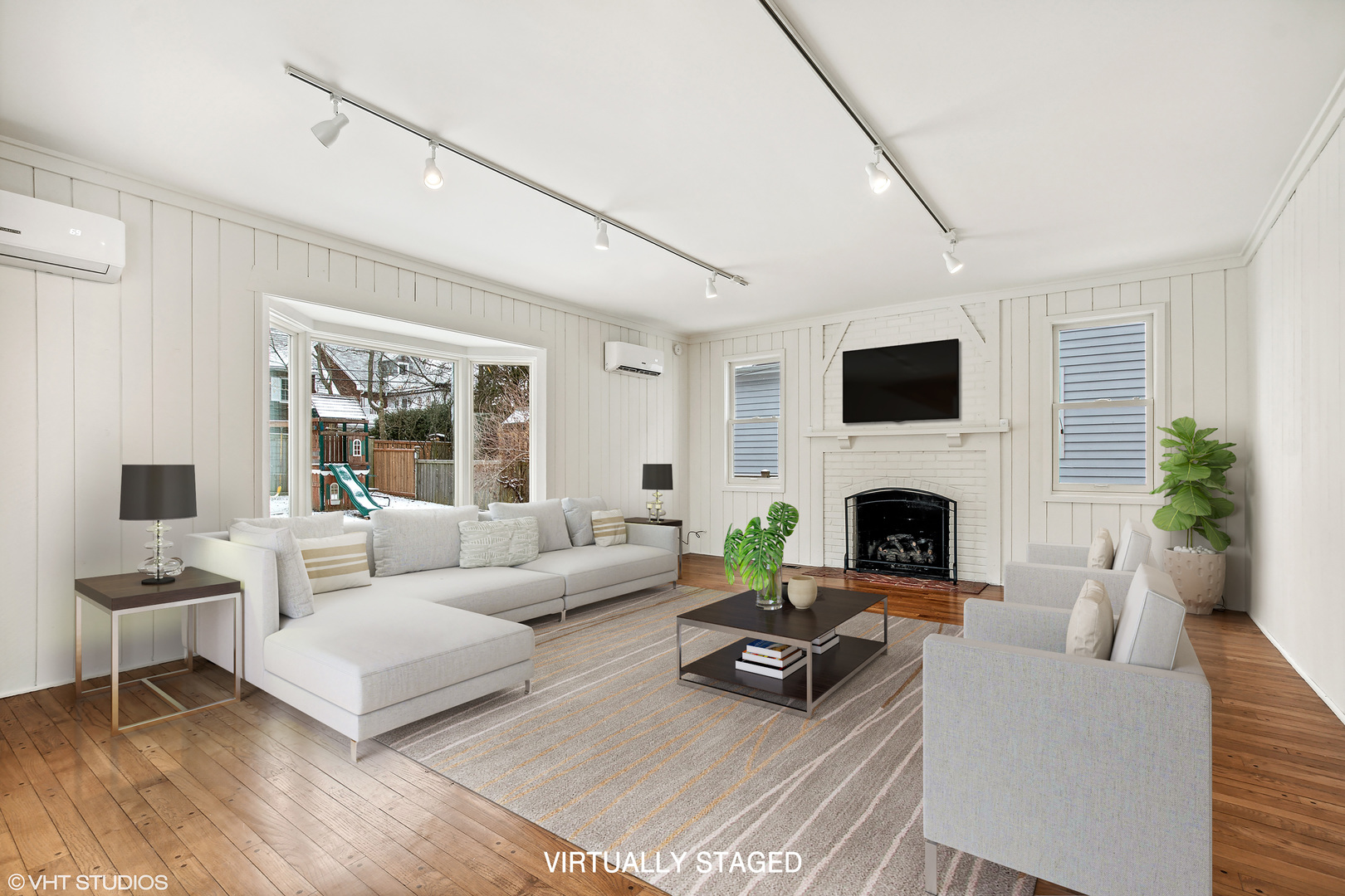 574 Braeside Road Highland Park, IL 60035 - Photo 9 of 29 a living room with furniture a fireplace and a flat screen tv