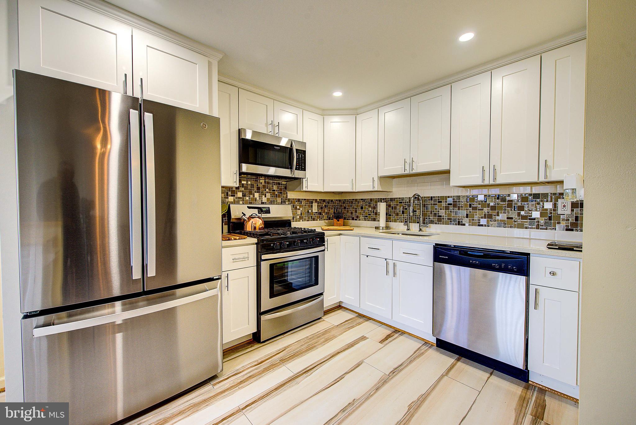 1367 Adair Road Brookhaven, PA 19015 - Photo 12 of 34 a kitchen with stainless steel appliances a refrigerator stove and microwave