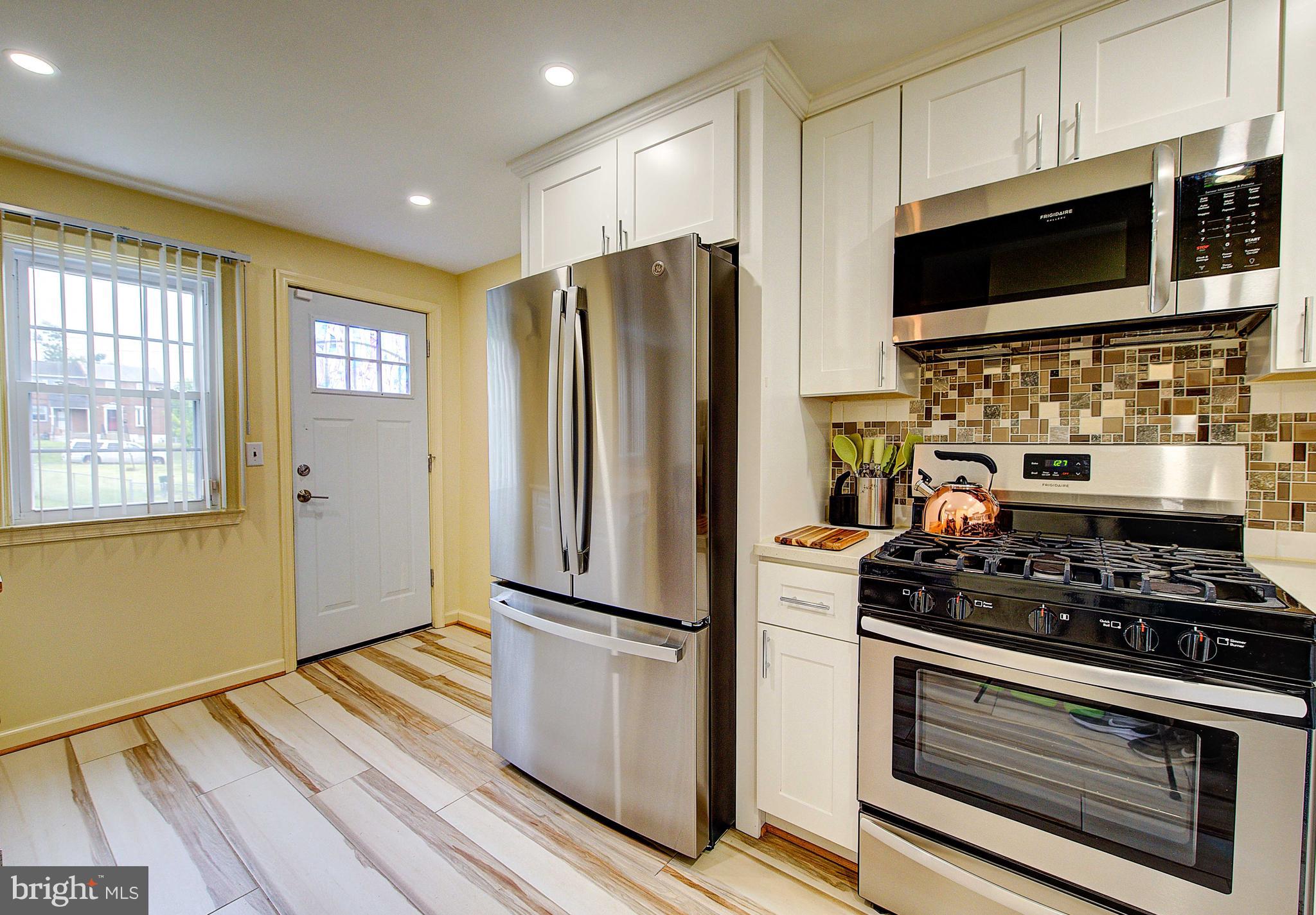 1367 Adair Road Brookhaven, PA 19015 - Photo 13 of 34 a kitchen with stainless steel appliances a refrigerator stove and microwave