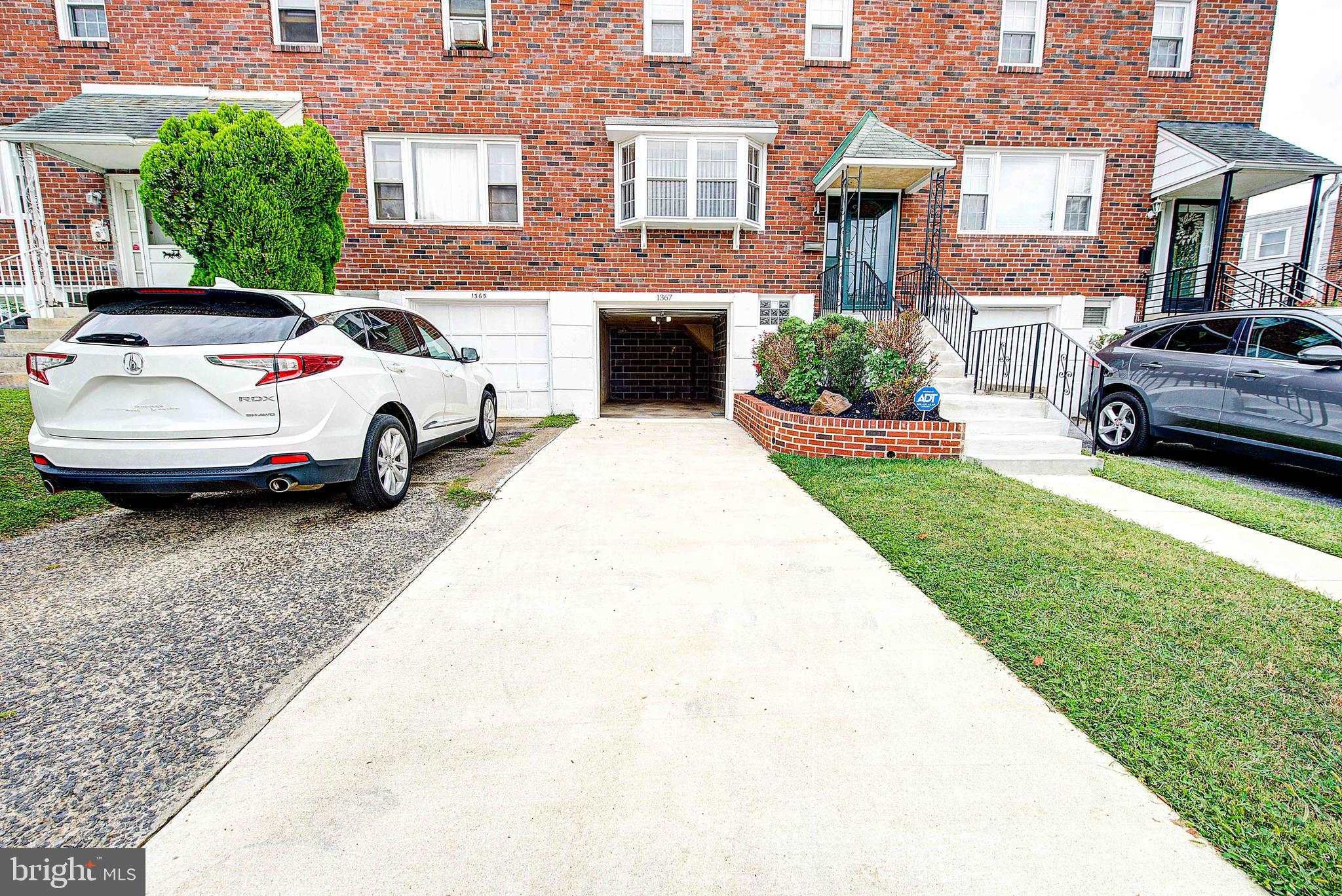 1367 Adair Road Brookhaven, PA 19015 - Photo 2 of 34 a view of a cars park in front of a building