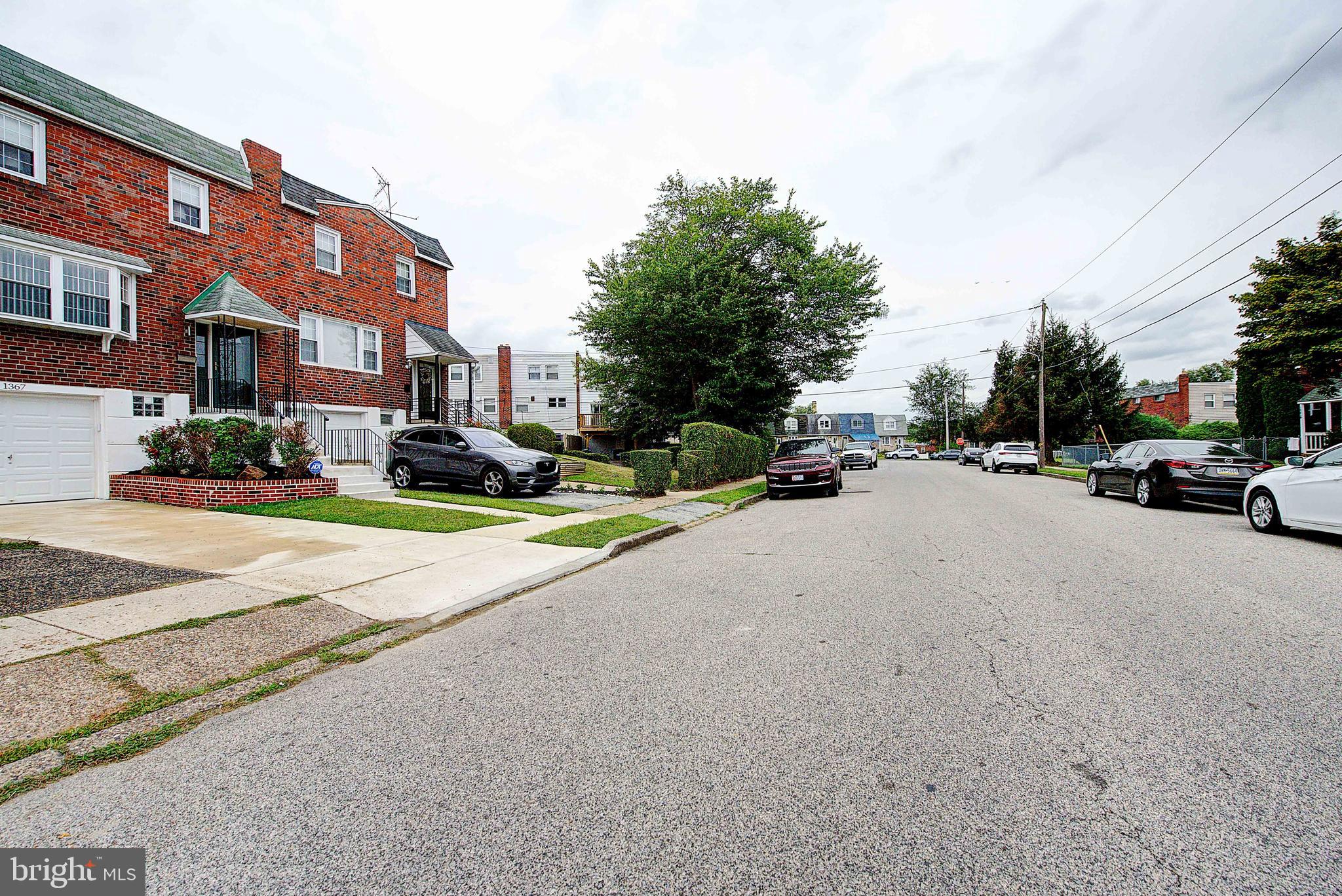 1367 Adair Road Brookhaven, PA 19015 - Photo 32 of 34 a view of road with card parked on side and retail shops