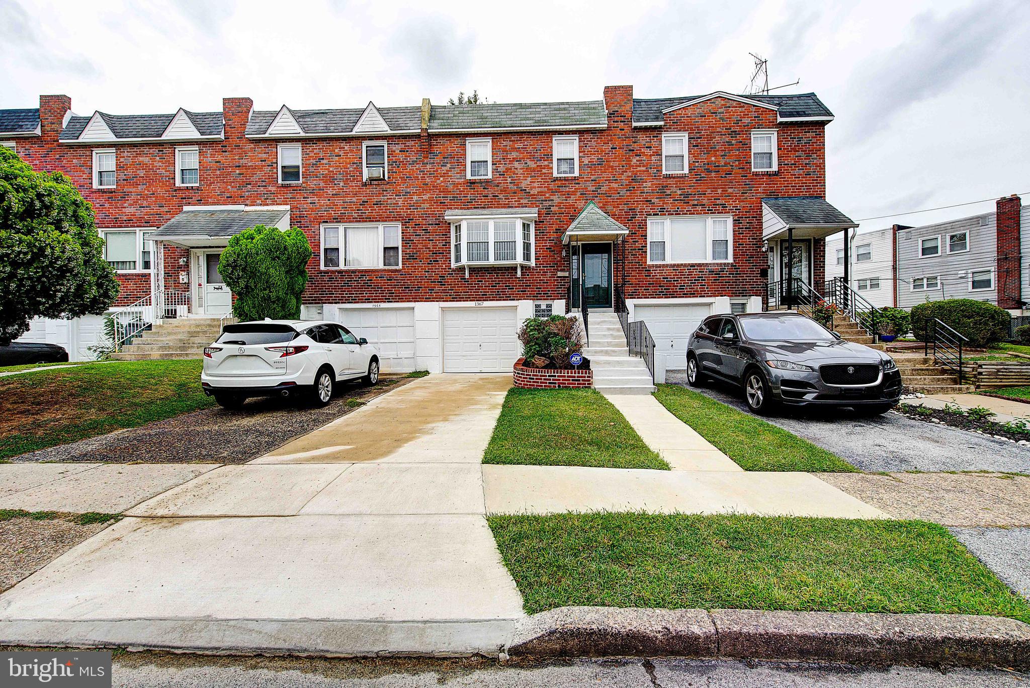 1367 Adair Road Brookhaven, PA 19015 - Photo 34 of 34 a front view of a residential apartment building with a yard