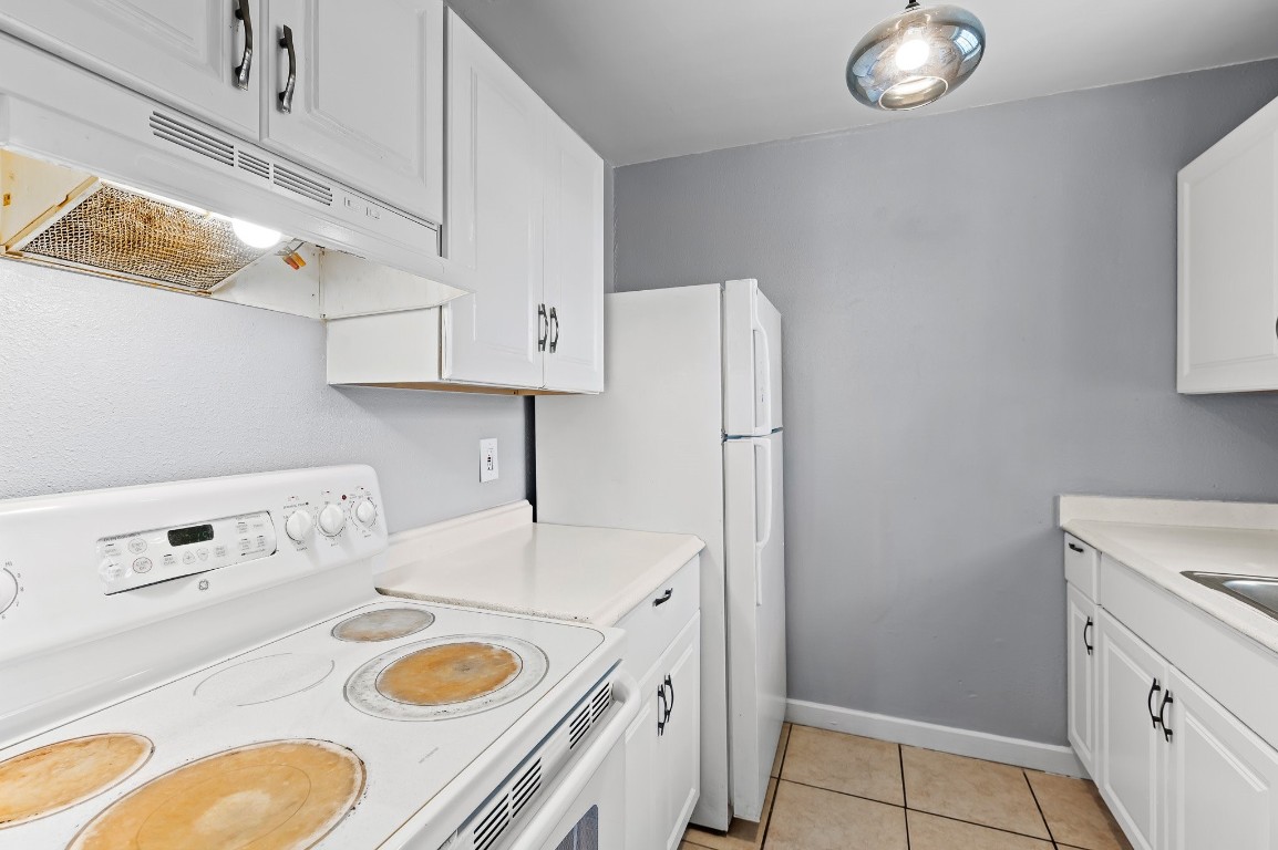 7617 Meador Avenue, Unit A Austin, TX 78752 - Photo 13 of 21 a kitchen with a refrigerator and a stove