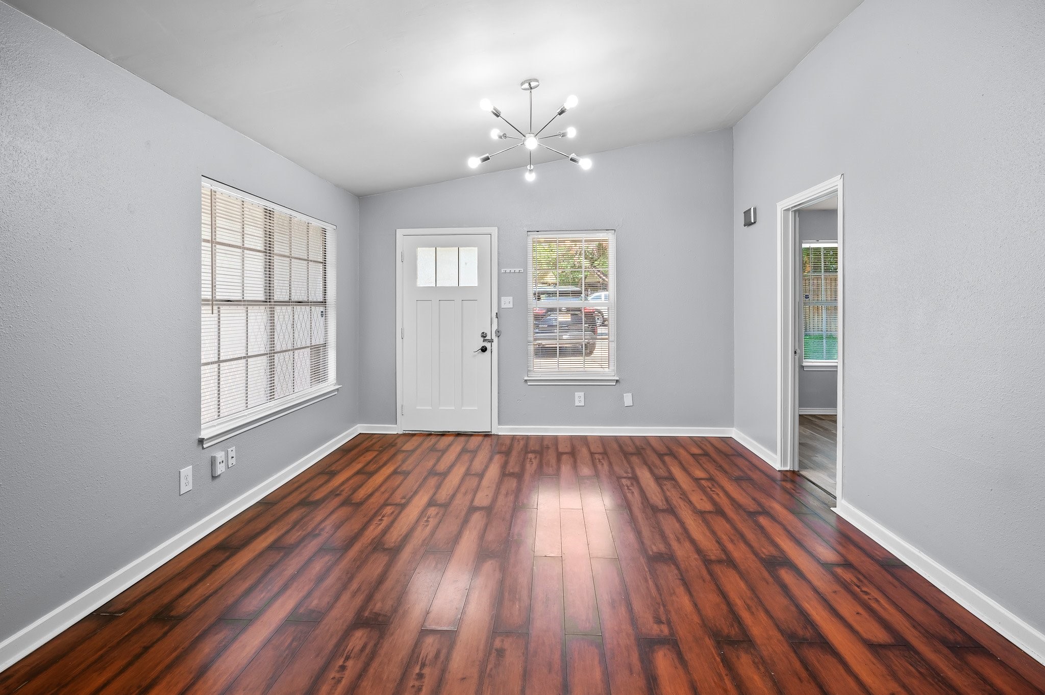 7617 Meador Avenue, Unit A Austin, TX 78752 - Photo 4 of 21 wooden floor in an empty room with a window