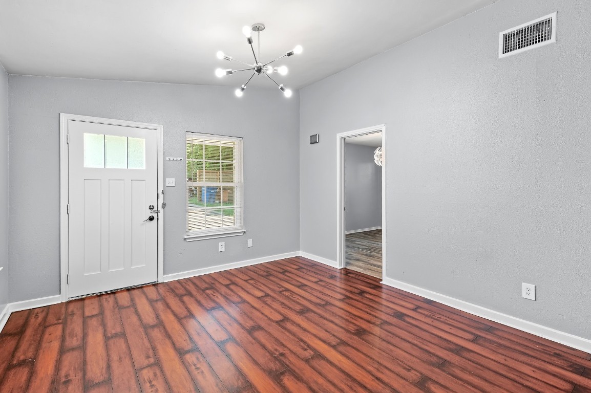 7617 Meador Avenue, Unit A Austin, TX 78752 - Photo 5 of 21 a view of an empty room with wooden floor and a window