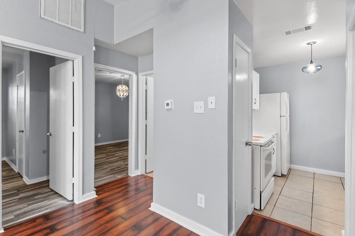 7617 Meador Avenue, Unit A Austin, TX 78752 - Photo 6 of 21 a view of a hallway with wooden floor and a bathroom