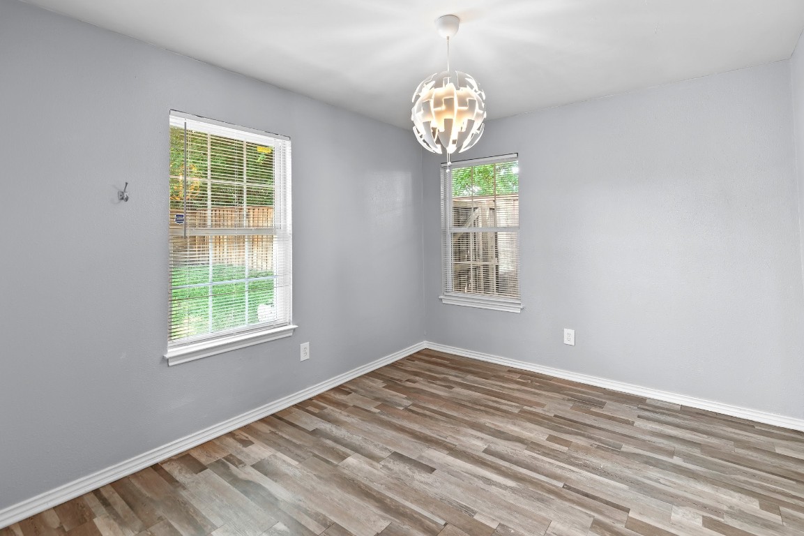 7617 Meador Avenue, Unit A Austin, TX 78752 - Photo 7 of 21 a view of an empty room with window and wooden floor
