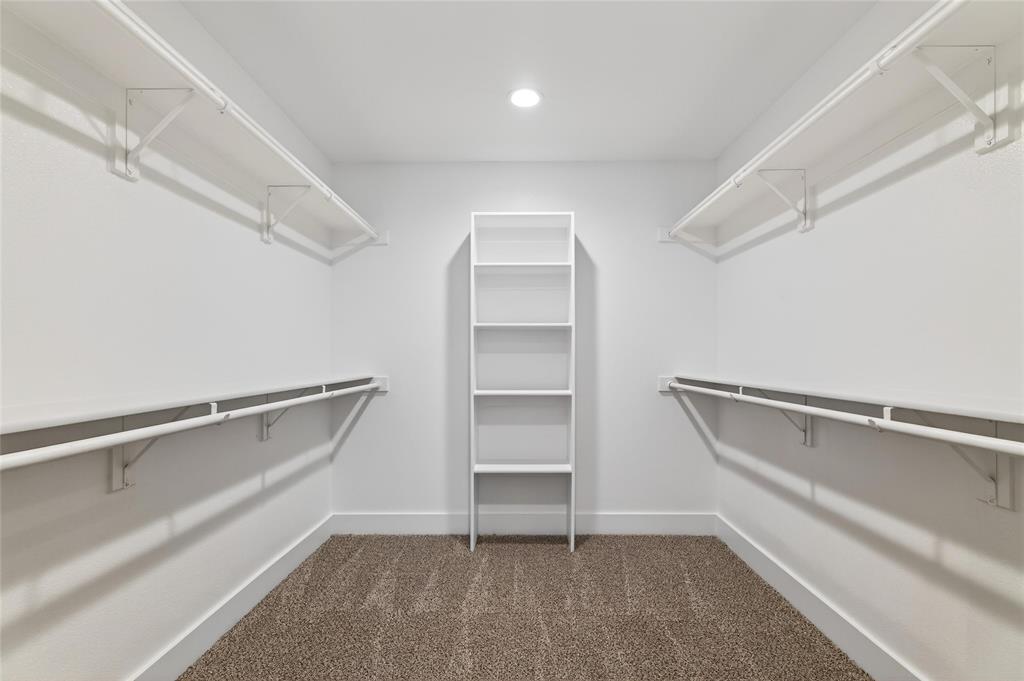 8901 Lowell Street Rowlett, TX 75089 - Photo 16 of 24 Walk in closet featuring dark carpet