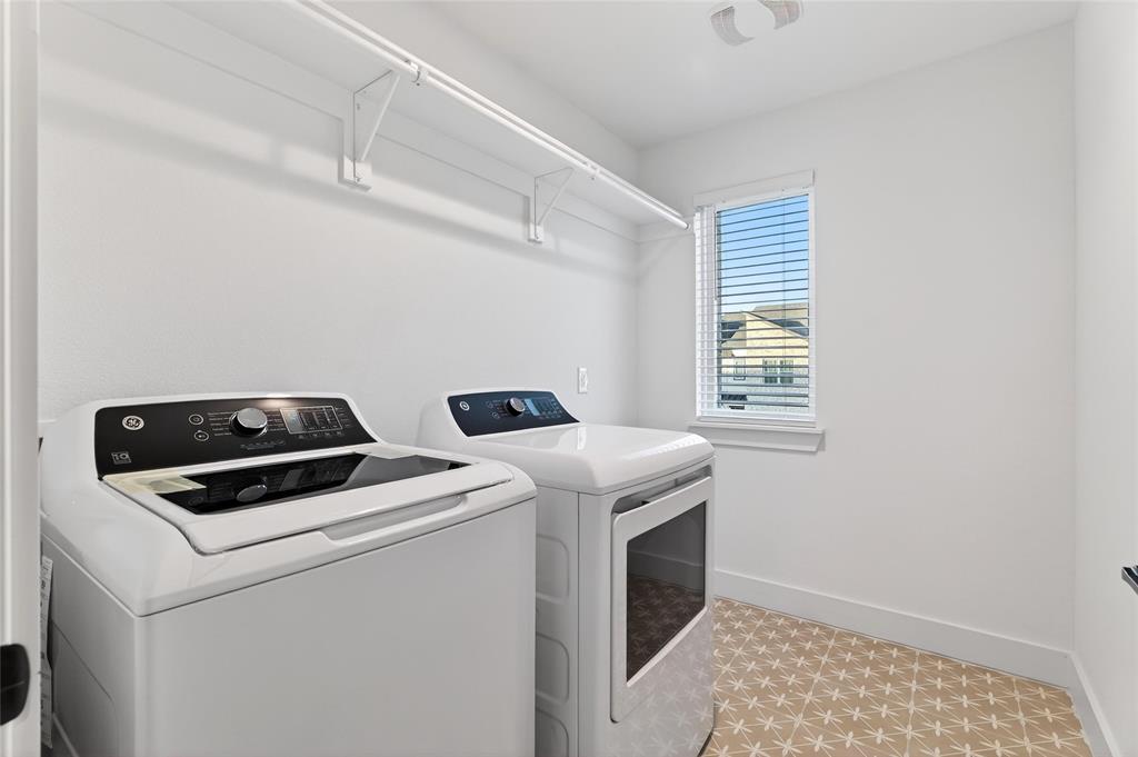 8901 Lowell Street Rowlett, TX 75089 - Photo 19 of 24 Laundry room with baseboards and washer and clothes dryer