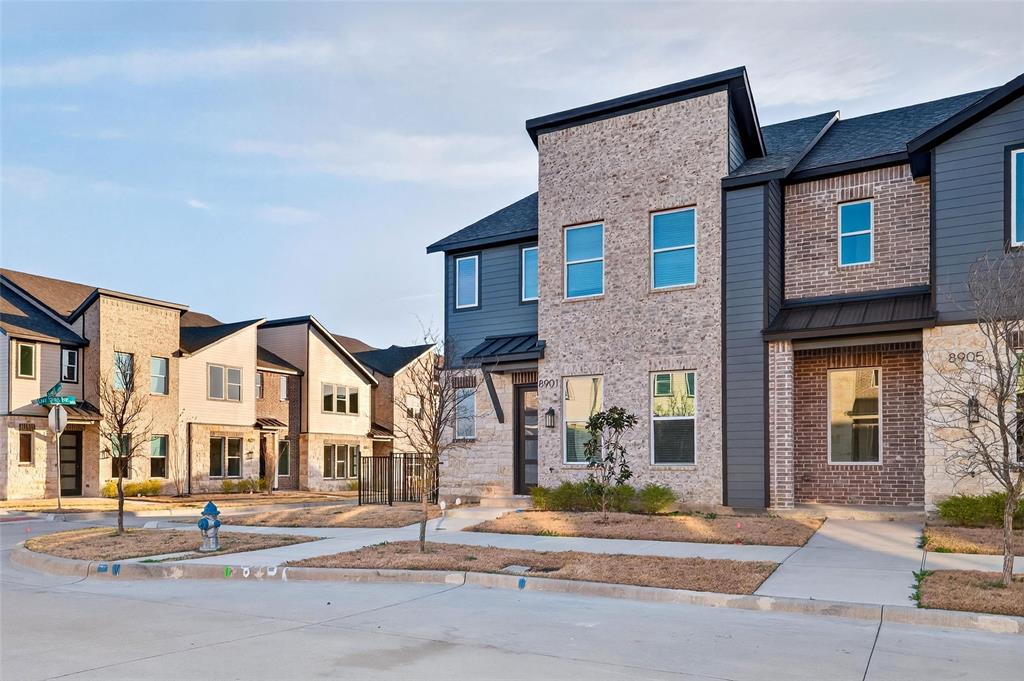 8901 Lowell Street Rowlett, TX 75089 - Photo 2 of 24 Contemporary home with a residential view, brick siding, and a metal roof