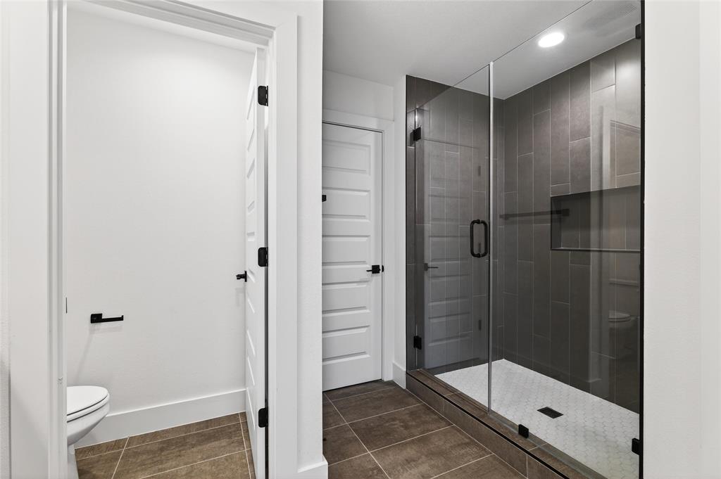 8901 Lowell Street Rowlett, TX 75089 - Photo 21 of 24 Full bath with a stall shower, recessed lighting, and dark tile patterned flooring