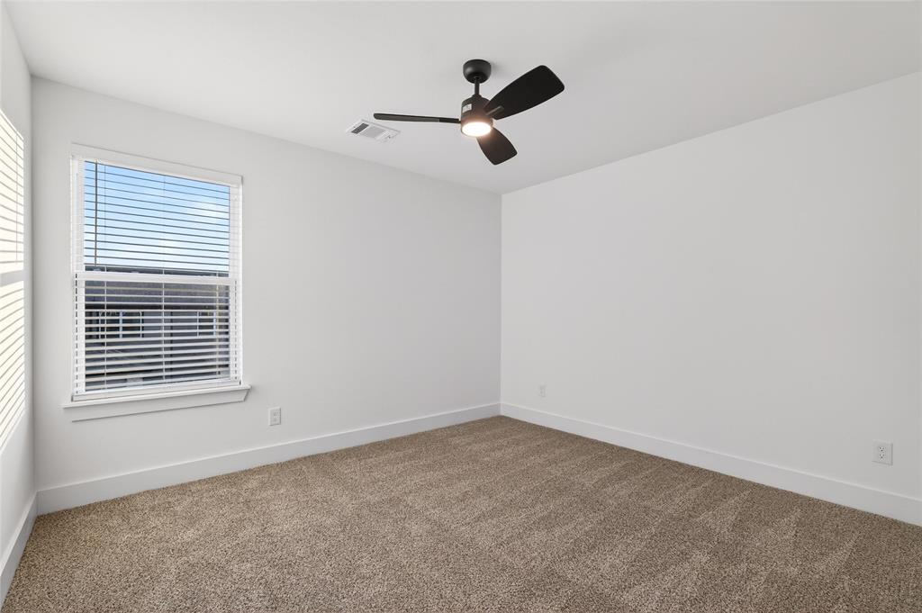 8901 Lowell Street Rowlett, TX 75089 - Photo 23 of 24 Unfurnished room featuring dark colored carpet and a ceiling fan