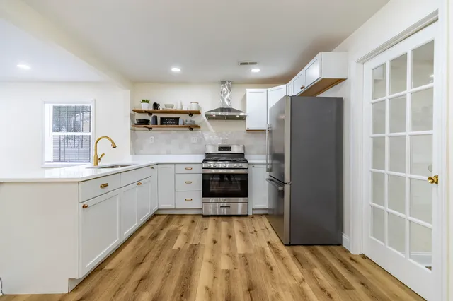 a kitchen with a refrigerator and a sink