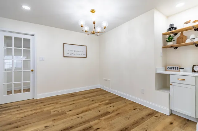 a view of a room with wooden floor and cabinet