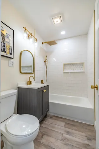 a bathroom with a toilet a sink and bathtub