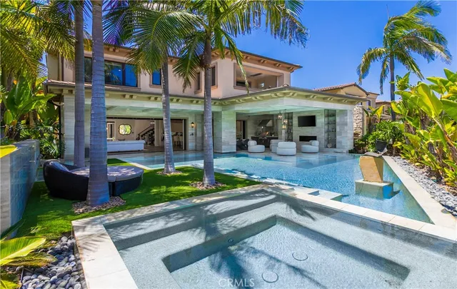 a view of a house with fountain bath tub and palm trees