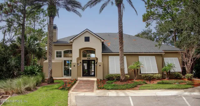 a living room with fireplace furniture and two windows
