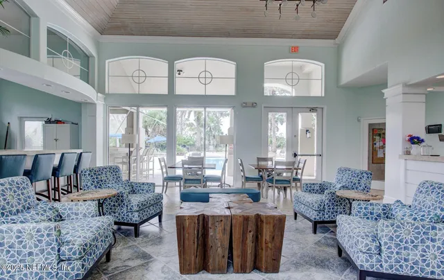 a living room with furniture a table and a large window
