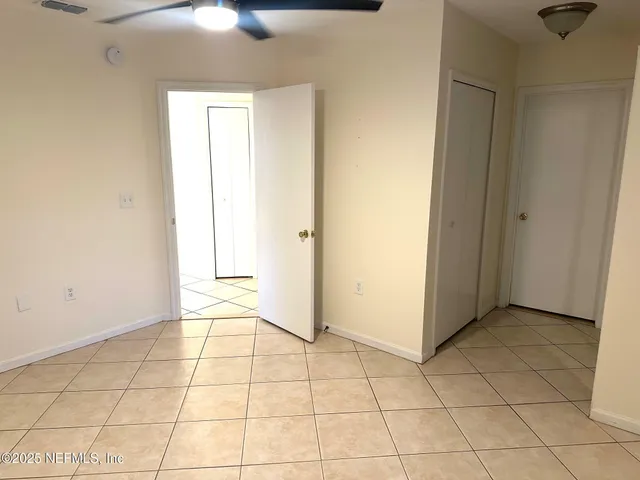 an empty room with windows and closet