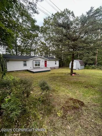 a kitchen with stainless steel appliances granite countertop a stove a sink dishwasher a dining table and chairs with wooden floor