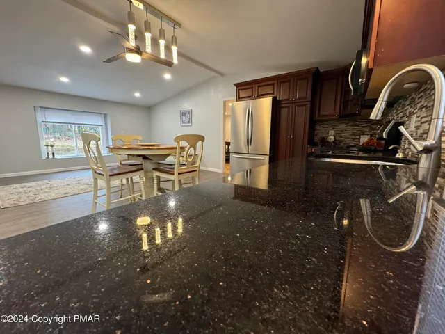 a kitchen with a table and chairs in it