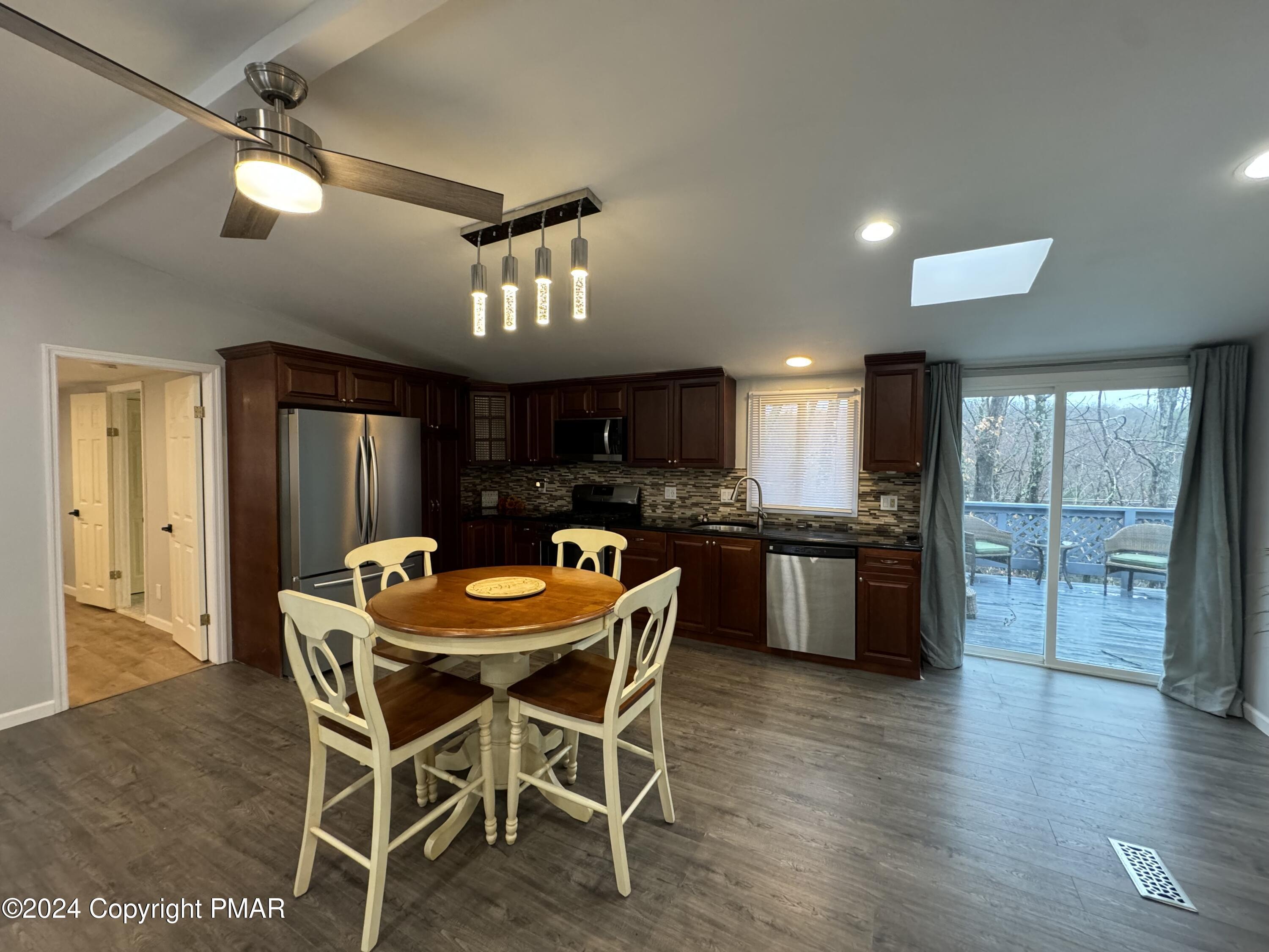 40 Prescott Road White Haven, PA 18661 - Photo 7 of 48 a kitchen with stainless steel appliances kitchen island granite countertop a dining table chairs and granite counter tops