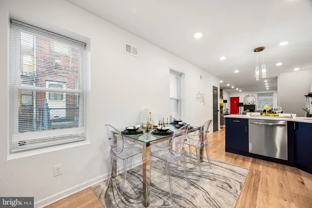 a kitchen with a table and chairs in it
