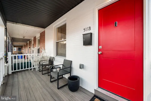 a view of balcony with wooden floor and seating space