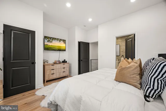 a bedroom with a bed and a flat screen tv