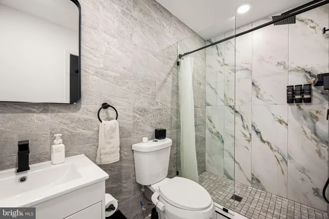 a white toilet sitting next to a bathroom sink