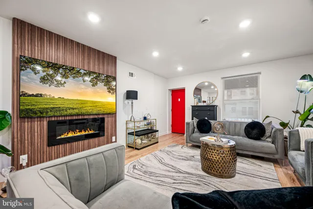 a living room with furniture fireplace and flat screen tv