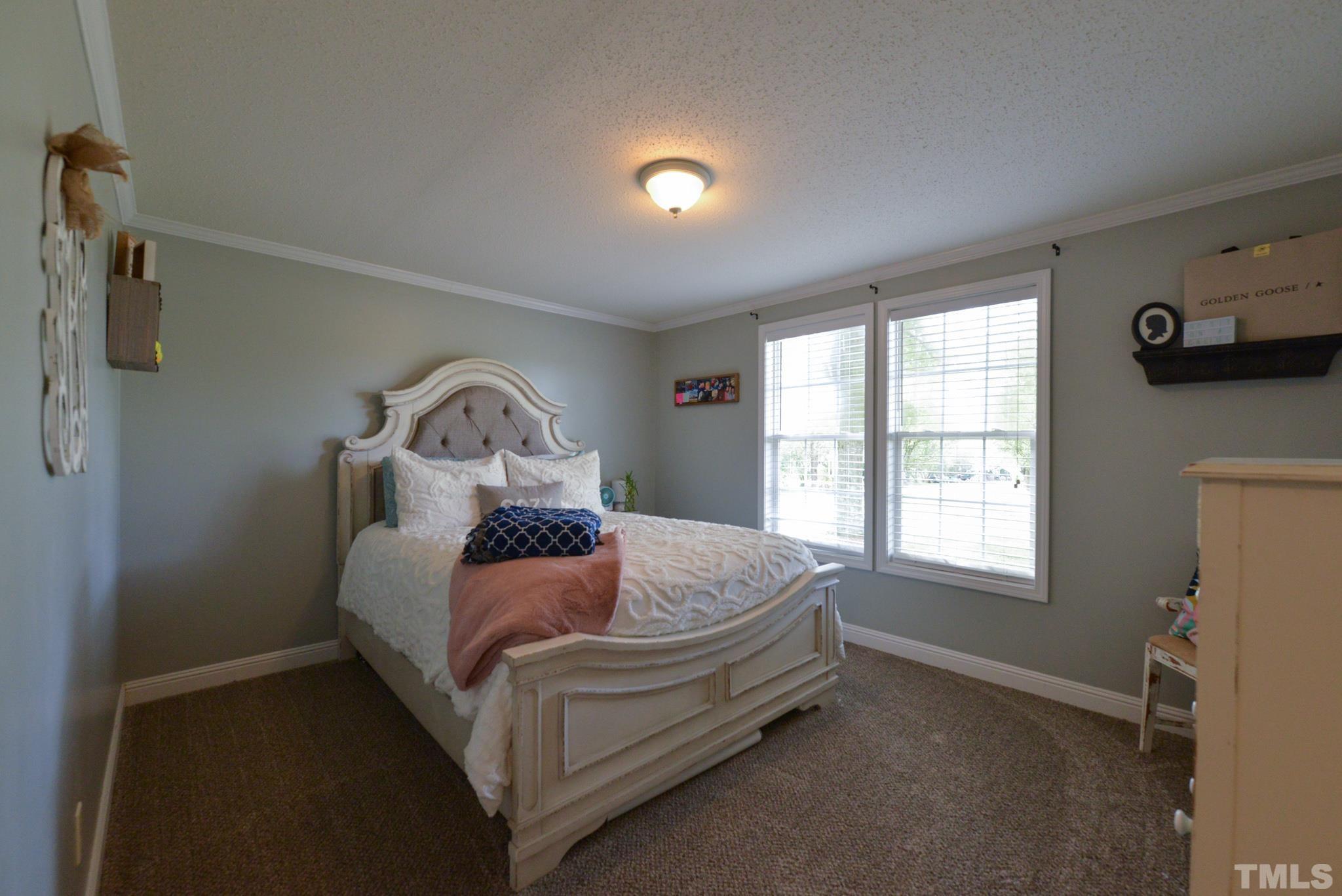 7175 Driver Road Zebulon, NC 27597 - Photo 16 of 30 a bedroom with a bed and a window