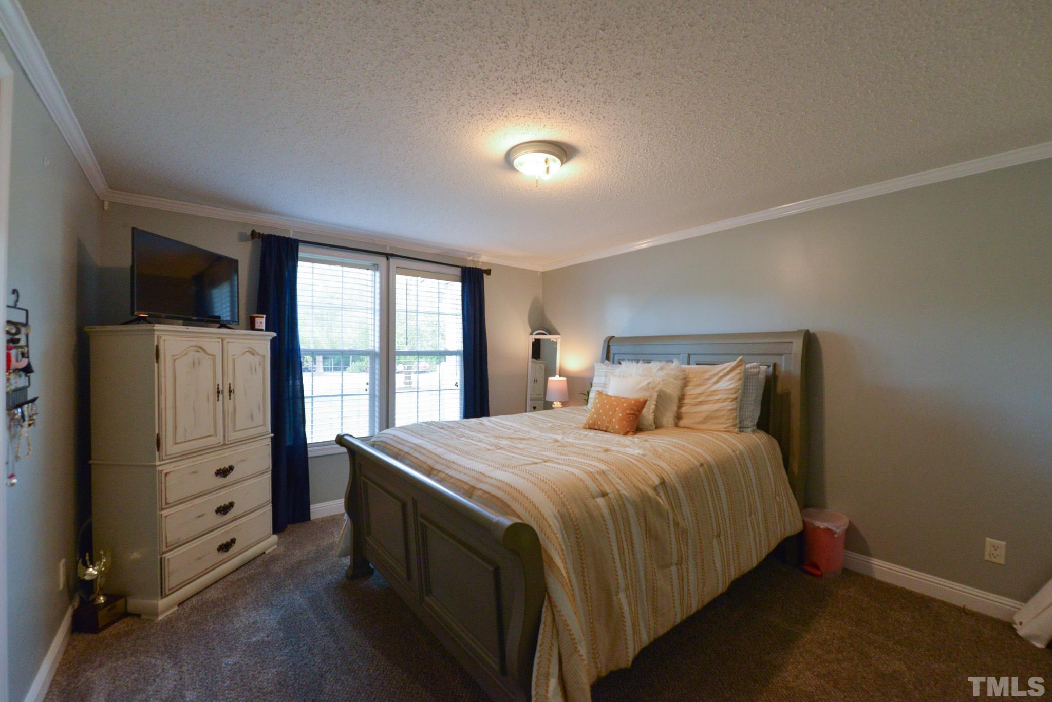 7175 Driver Road Zebulon, NC 27597 - Photo 19 of 30 a bedroom with a bed and a large window