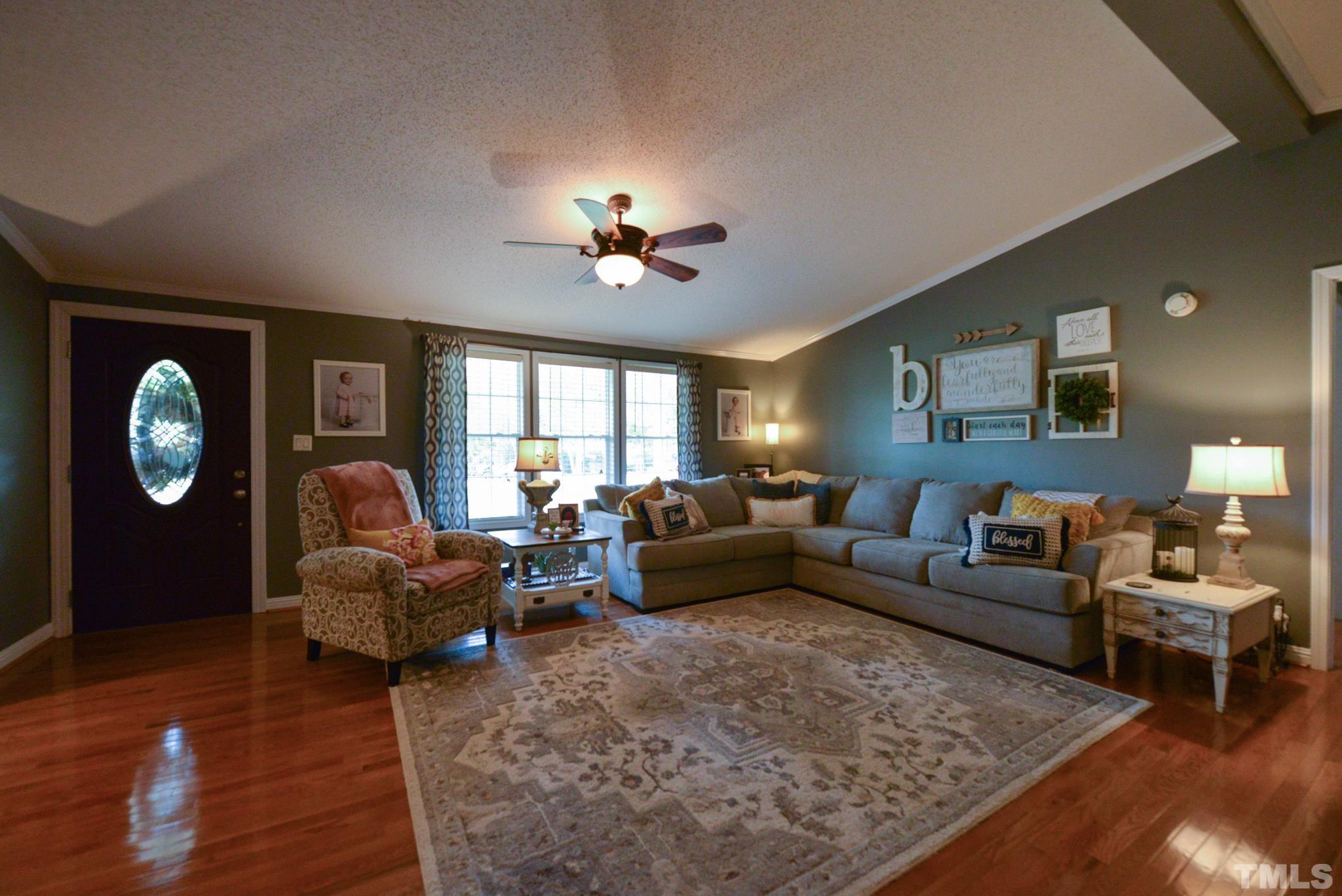 7175 Driver Road Zebulon, NC 27597 - Photo 3 of 30 a living room with furniture a rug potted plant and a window