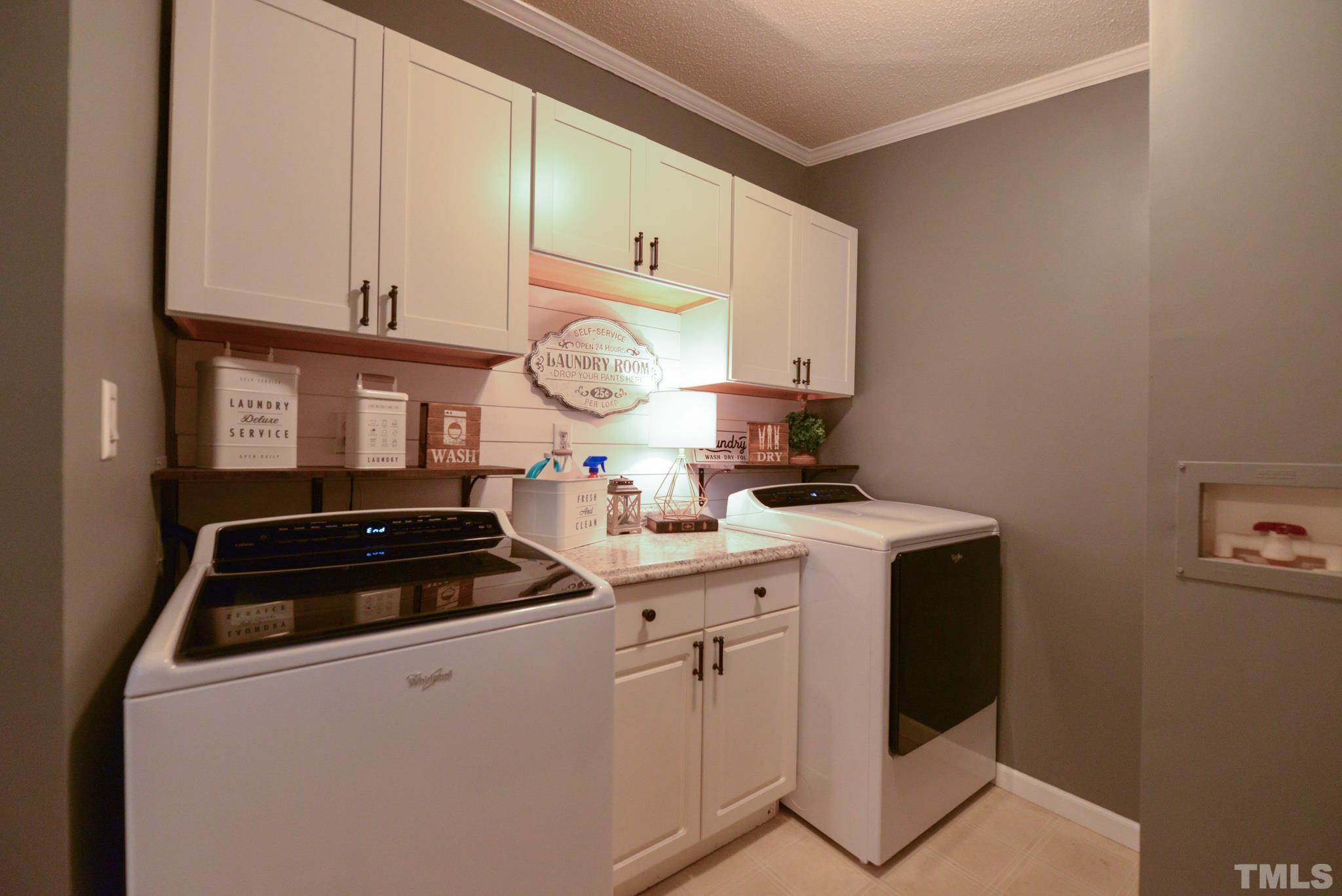 7175 Driver Road Zebulon, NC 27597 - Photo 21 of 30 a kitchen with granite countertop a sink a stove and cabinets