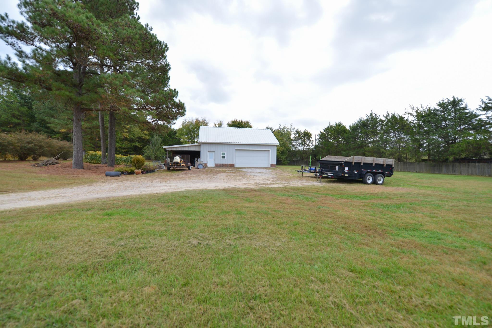 7175 Driver Road Zebulon, NC 27597 - Photo 28 of 30 a car parked in the middle of a field
