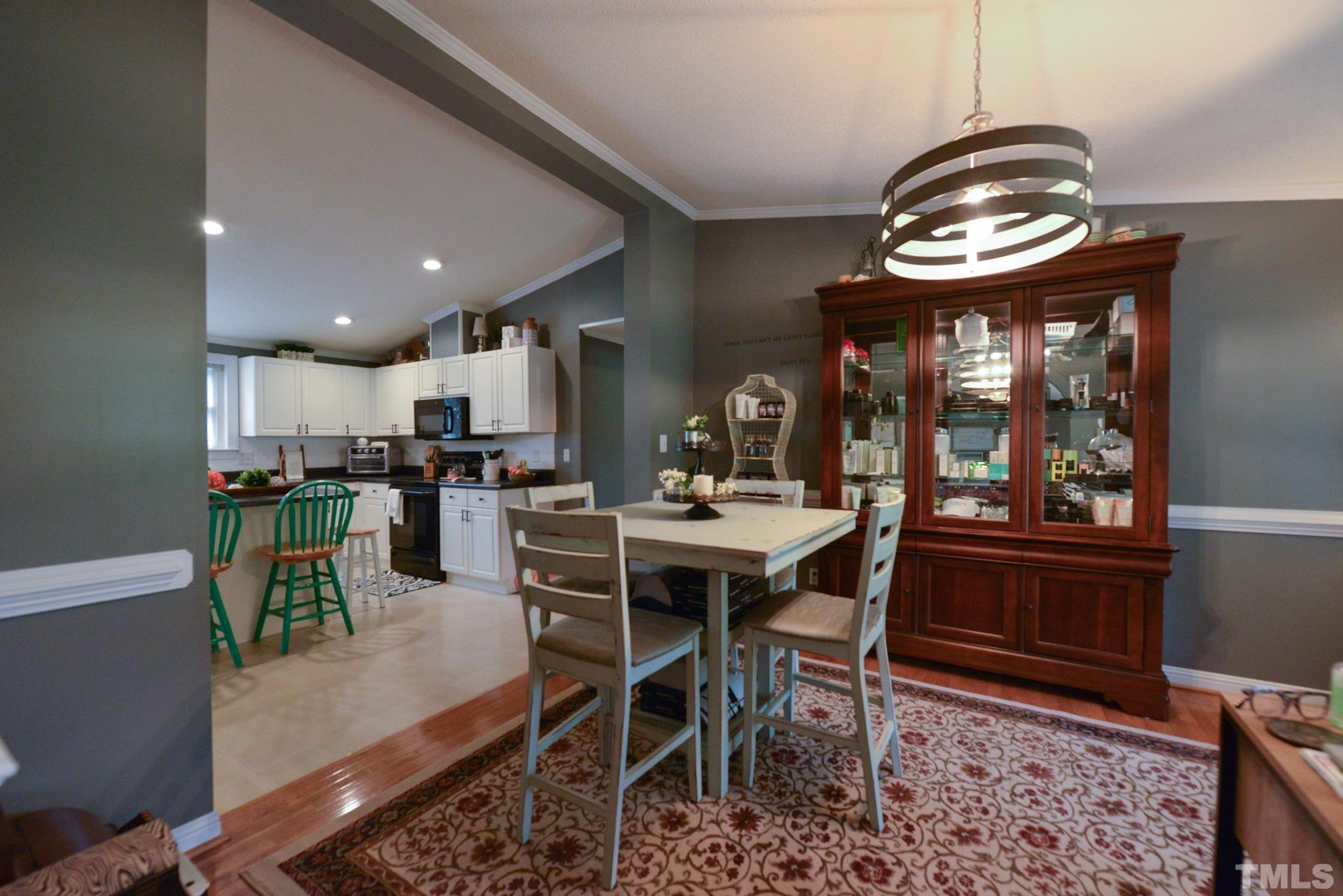 7175 Driver Road Zebulon, NC 27597 - Photo 7 of 30 a view of a dining room with furniture and chandelier