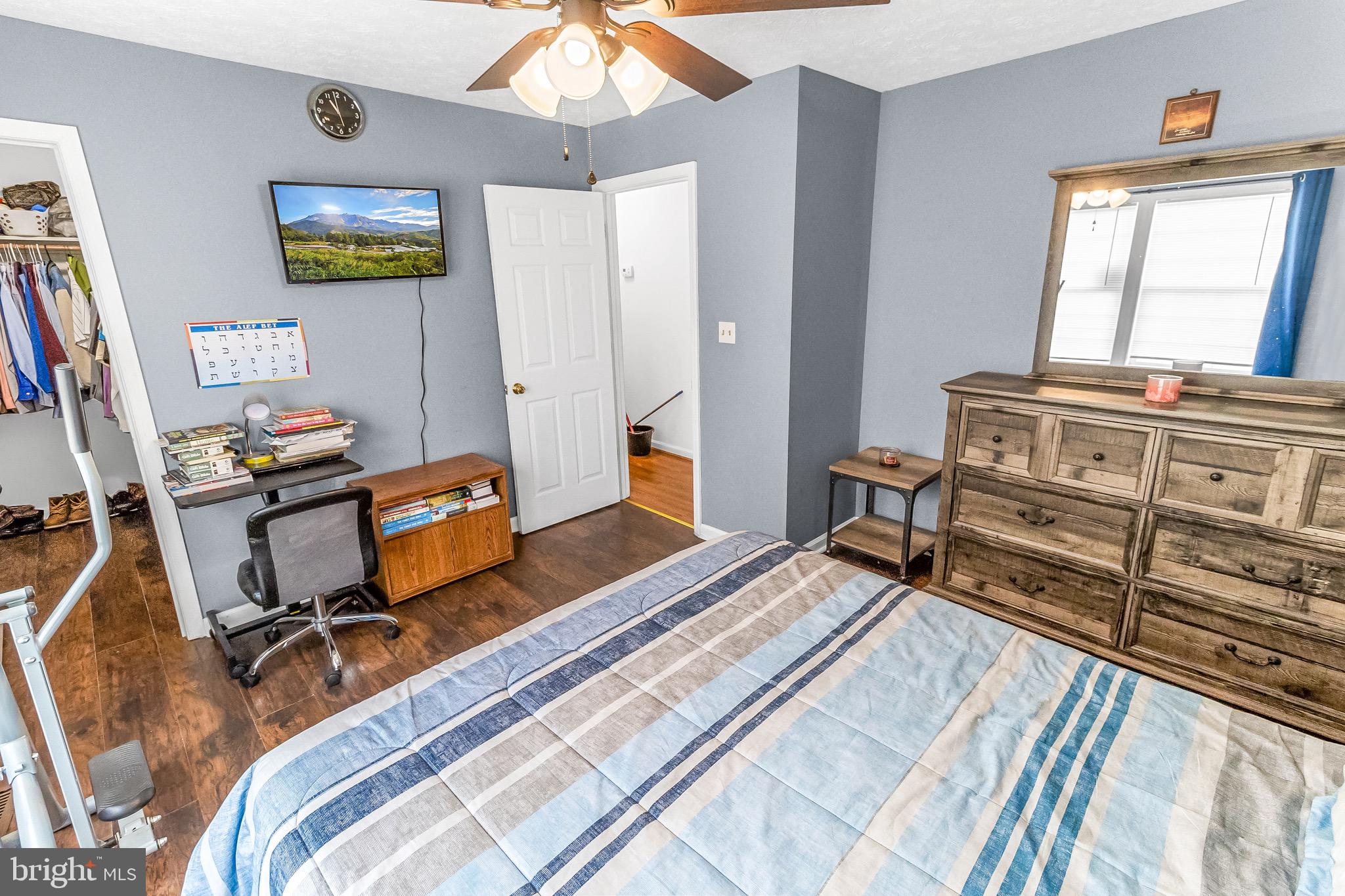 207 Preston Place Ranson, WV 25438 - Photo 12 of 32 a bedroom with a bed and wooden floor