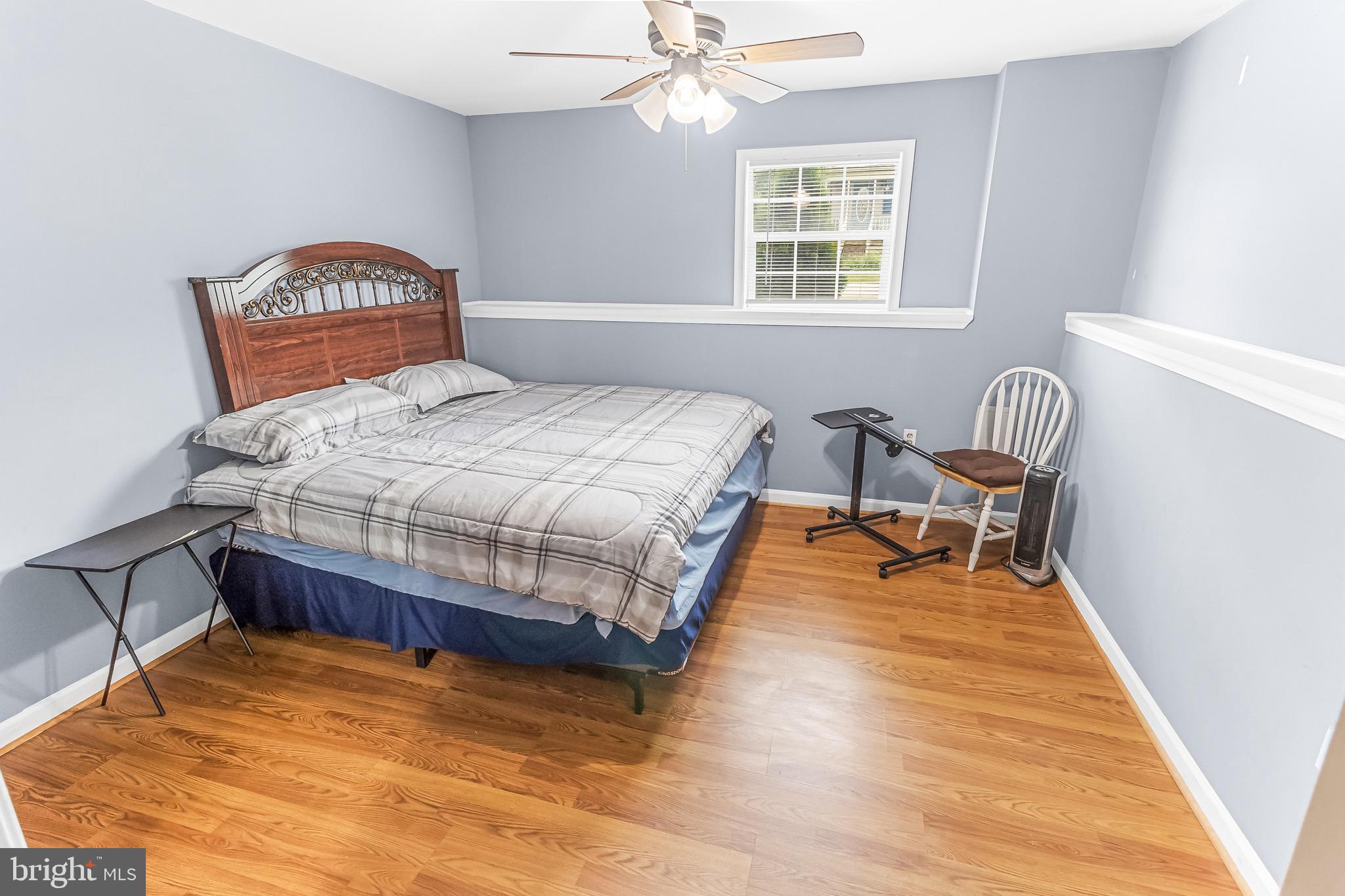 207 Preston Place Ranson, WV 25438 - Photo 18 of 32 a bedroom with a bed and a chair