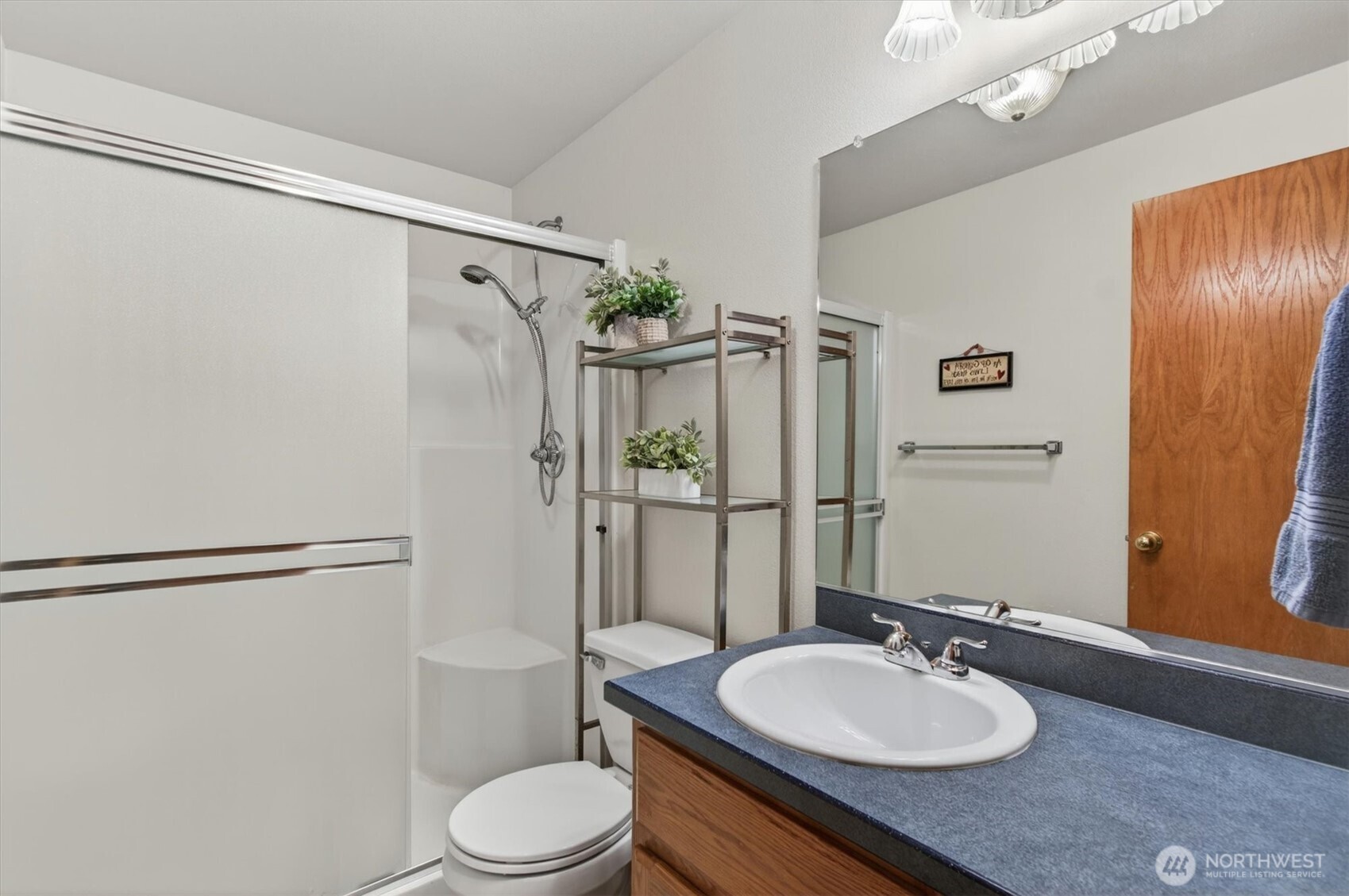 218 West Sunny Sands Road Cathlamet, WA 98612 - Photo 23 of 40 a bathroom with a granite countertop sink toilet a mirror and shower