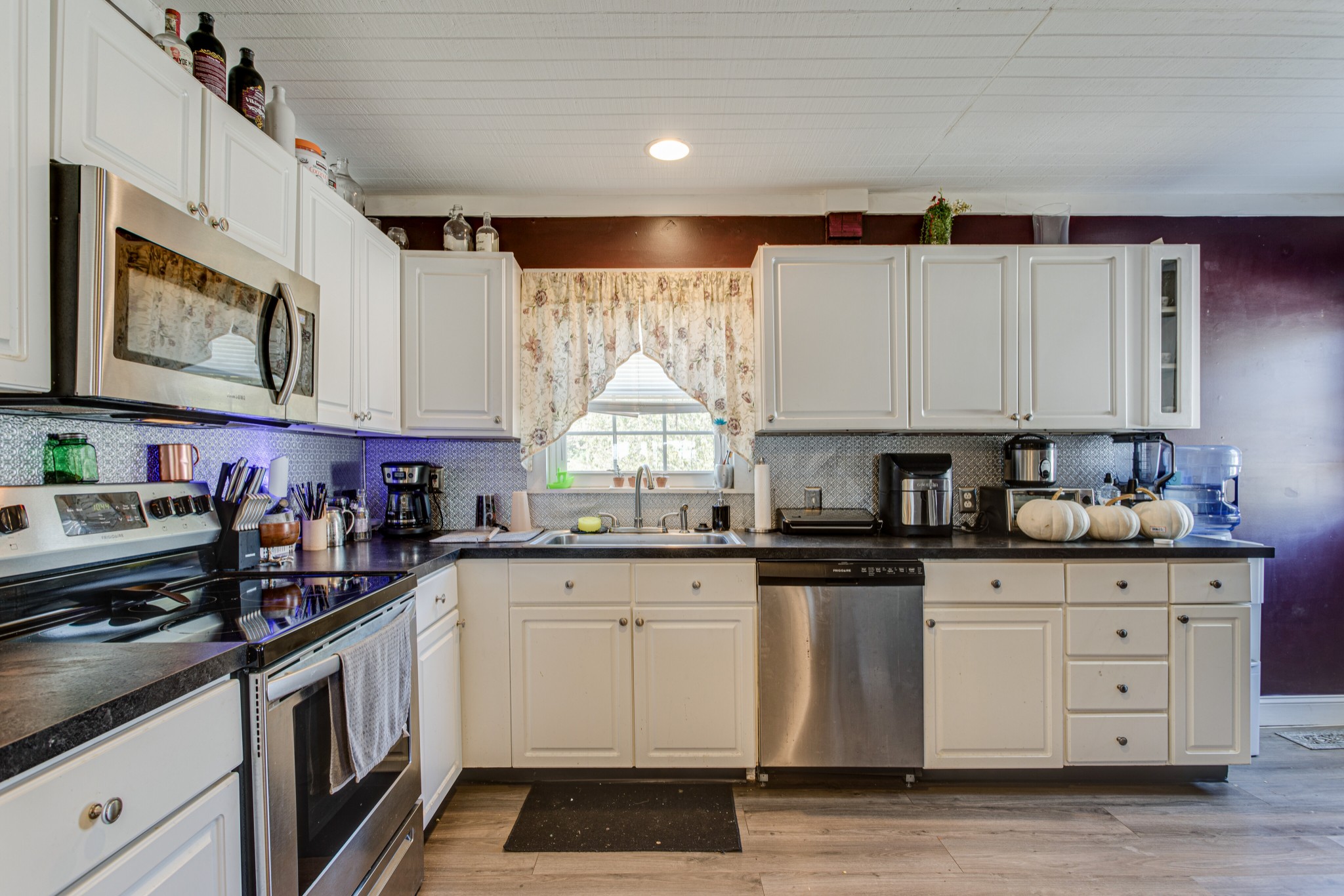 1394 Harpo Road Manchester, TN 37355 - Photo 11 of 32 a kitchen with stainless steel appliances granite countertop a stove a sink and a microwave