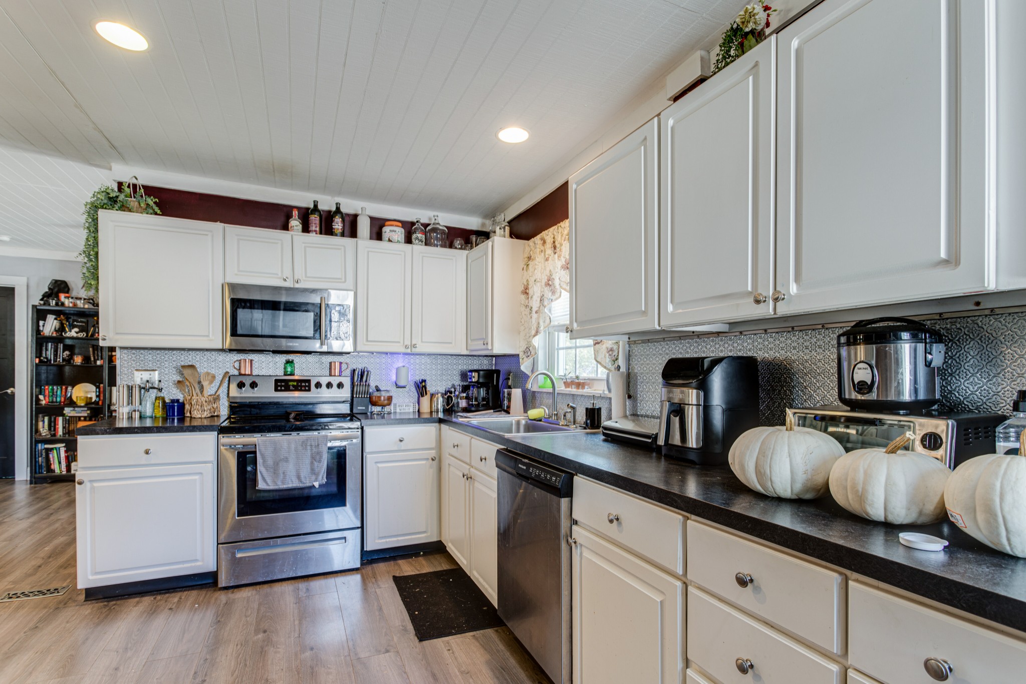 1394 Harpo Road Manchester, TN 37355 - Photo 14 of 32 a kitchen with granite countertop white cabinets and white appliances