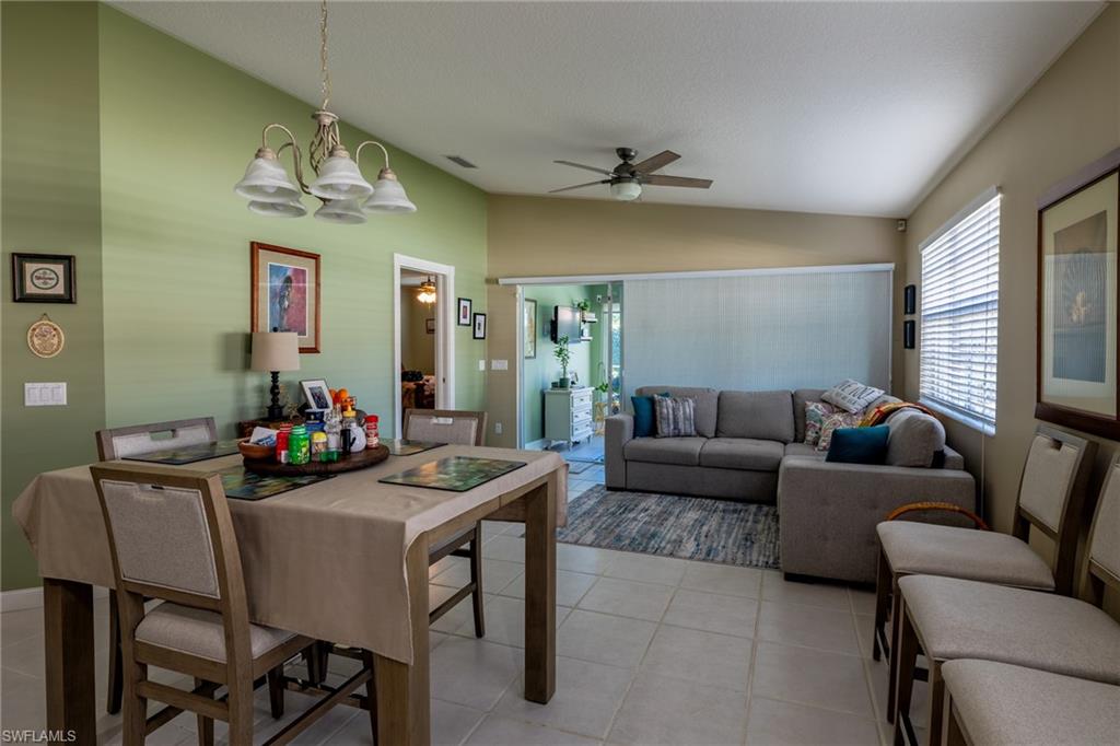 4167 St George Lane Naples, FL 34119 - Photo 4 of 14 a living room with furniture and a chandelier