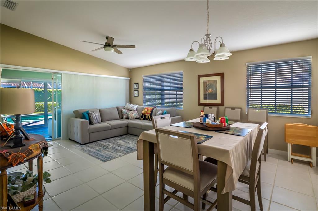 4167 St George Lane Naples, FL 34119 - Photo 5 of 14 a view of a livingroom and a dining room with furniture window and wooden floor