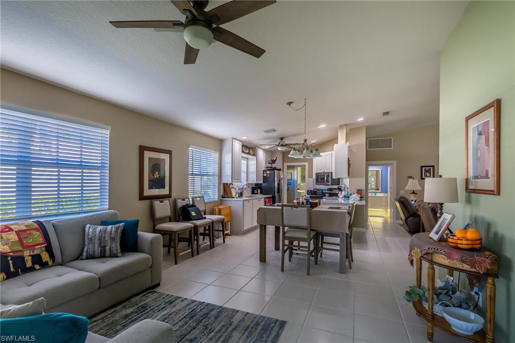4167 St George Lane Naples, FL 34119 - Photo 6 of 14 a living room with furniture and a large window