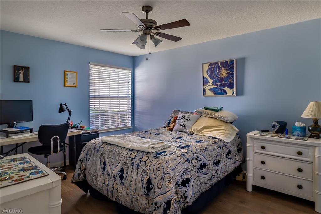 4167 St George Lane Naples, FL 34119 - Photo 9 of 14 a bedroom with a bed and a desk