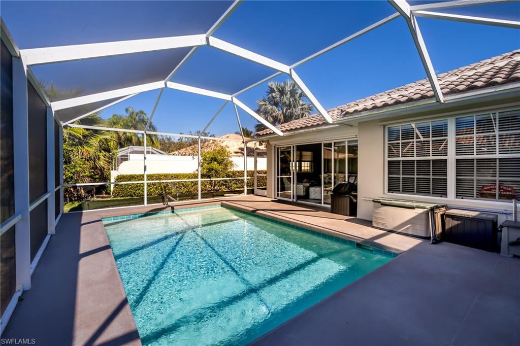 4167 St George Lane Naples, FL 34119 - Photo 10 of 14 a view of a backyard with swimming pool and sitting area