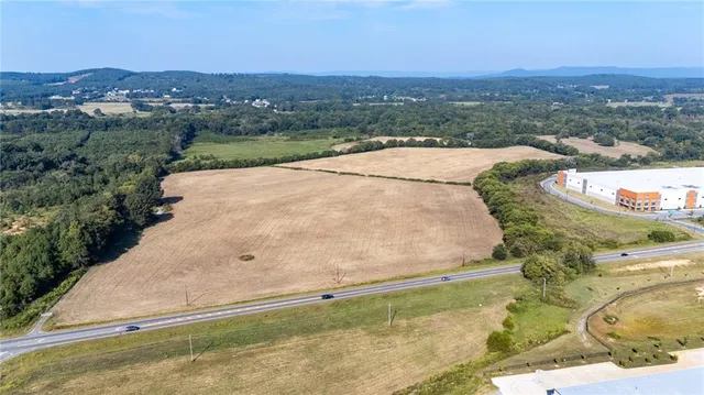 an aerial view of residential houses with outdoor space and trees
