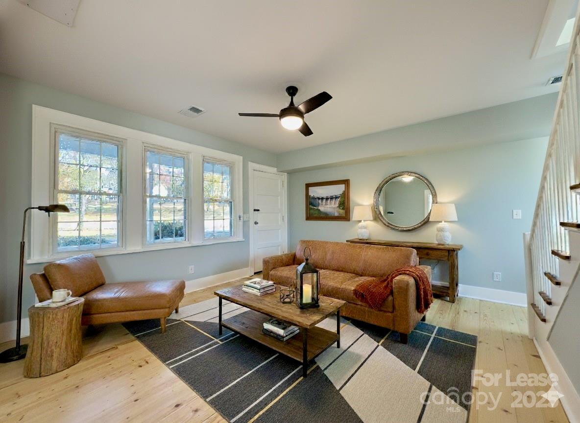 130 Maple Street Badin, NC 28009 - Photo 2 of 24 a living room with furniture ceiling fan and a rug