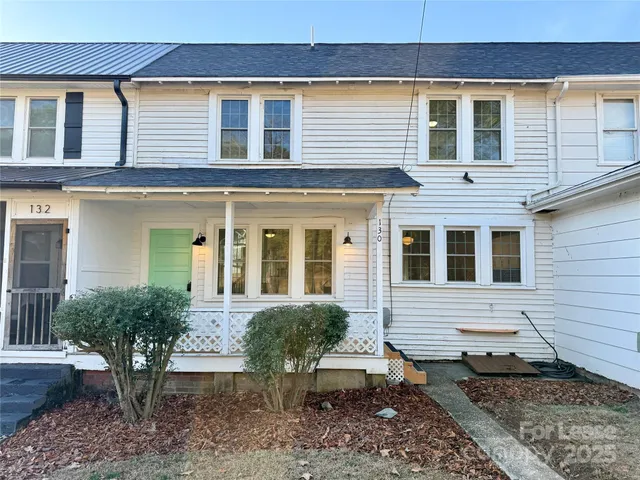a view of a house with a yard and sitting space